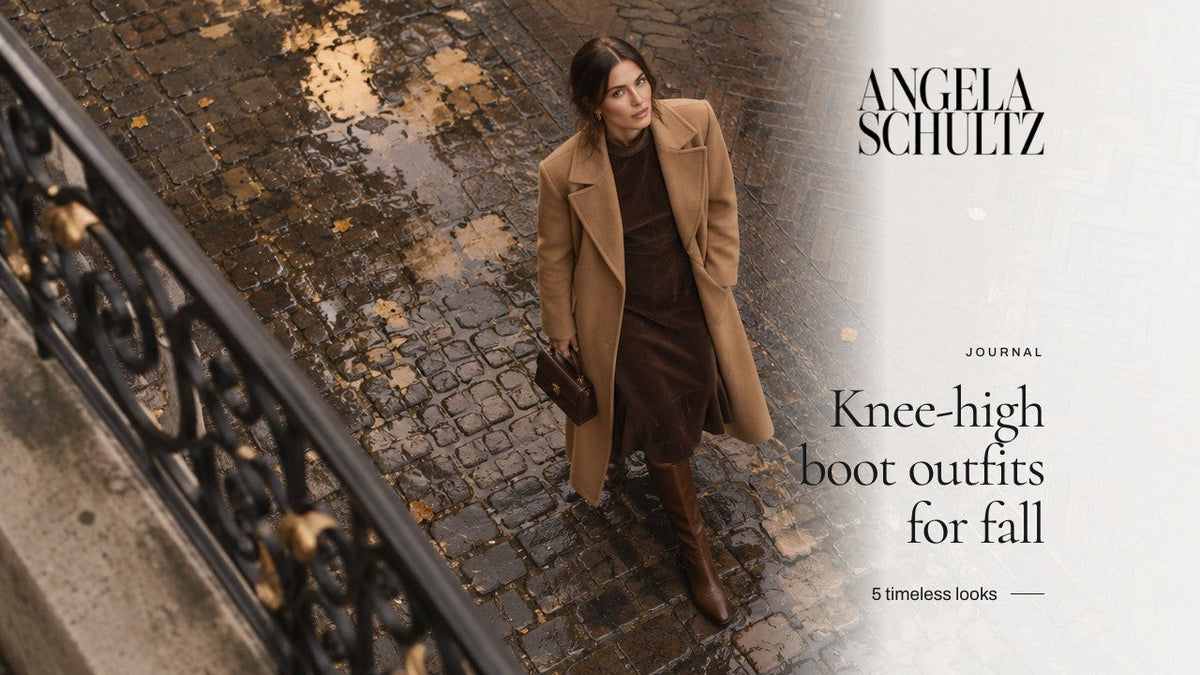 Woman in a long camel coat over a chocolate midi dress with tall brown boots on wet cobblestones